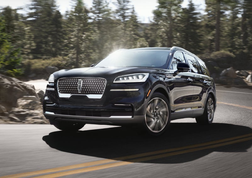 A Lincoln Aviator® SUV is being driven on a winding mountain road | Doggett Lincoln of Beaumont in Beaumont TX