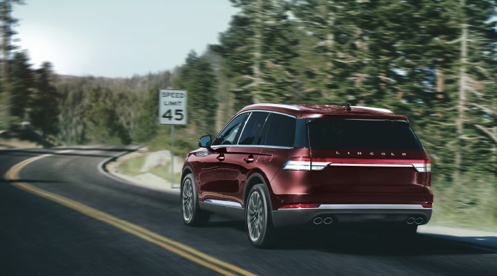 A 2024 Lincoln Aviator® SUV is being driven on a winding mountain road | Doggett Lincoln of Beaumont in Beaumont TX