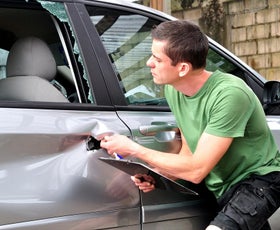 man checking car door damage | Doggett Lincoln of Beaumont in Beaumont TX