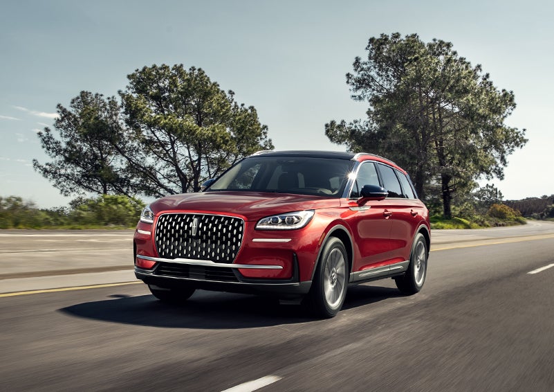 A 2024 Lincoln Corsair® SUV is shown being driven on a country road. | Doggett Lincoln of Beaumont in Beaumont TX