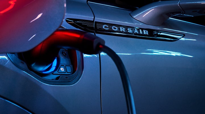 A charger plugged into the charging port of a 2024 Lincoln Corsair® Plug-in Hybrid model. | Doggett Lincoln of Beaumont in Beaumont TX